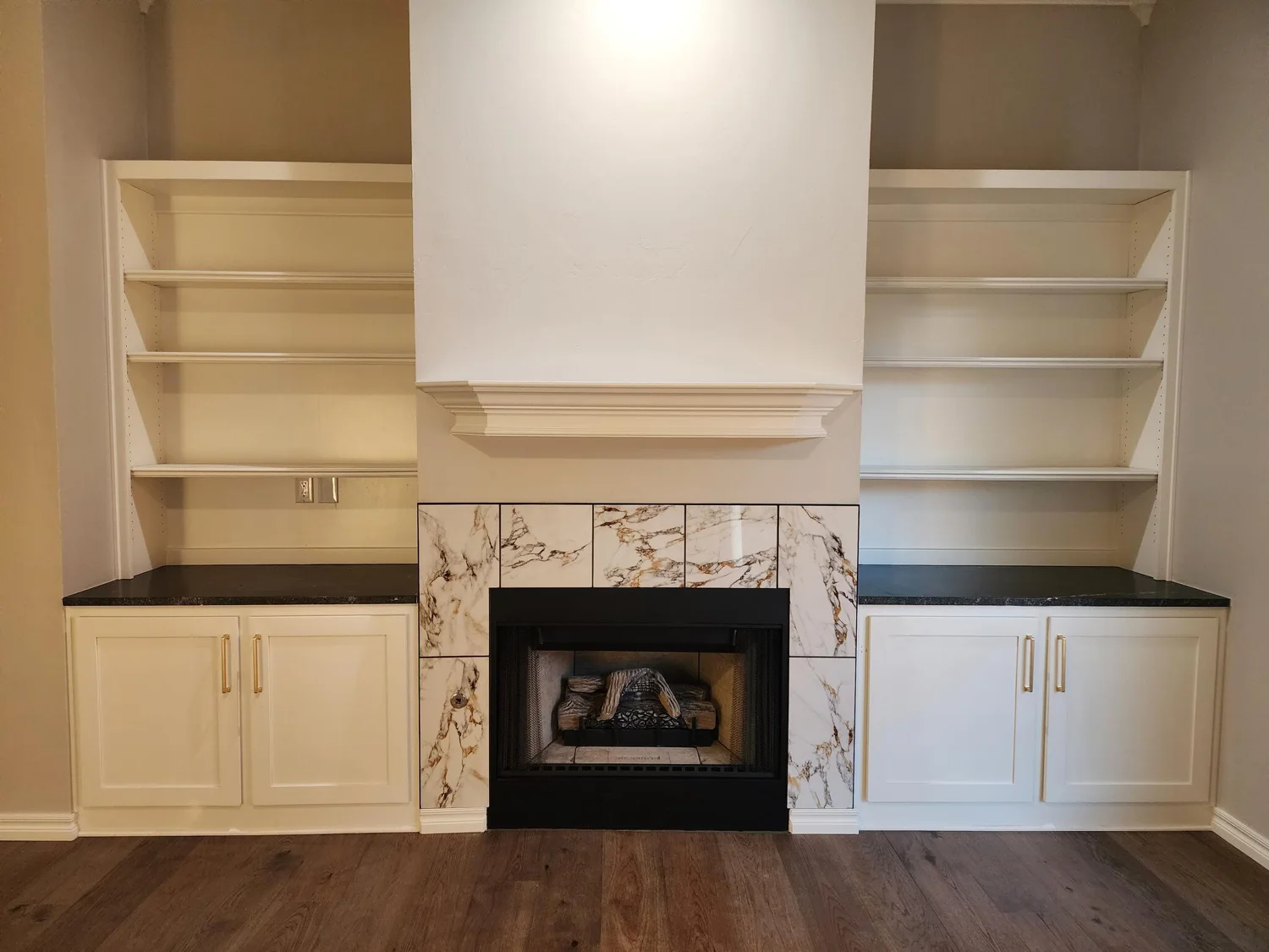 White custom shelving and cabinetry around a fireplace